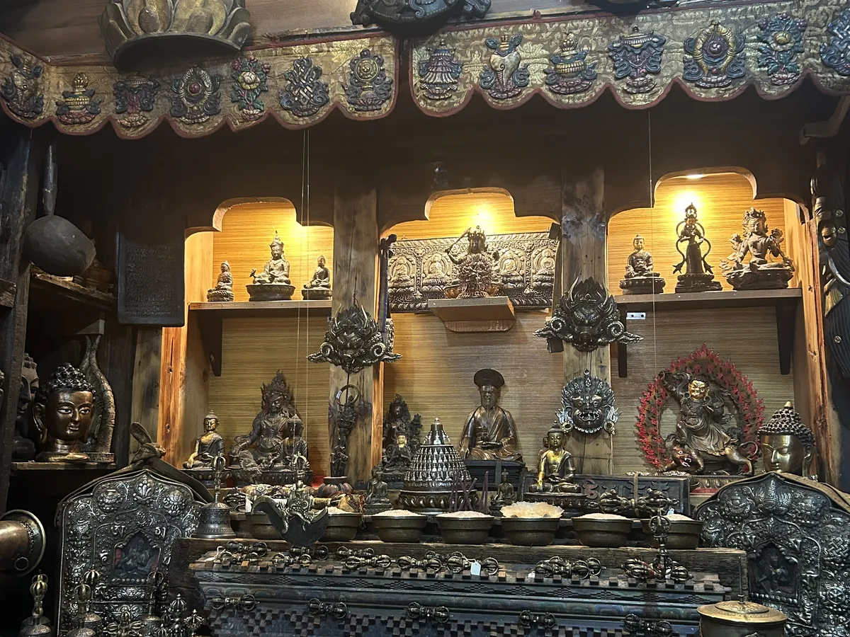 Brass and bronze stacked in an antique dealer&rsquo;s shop