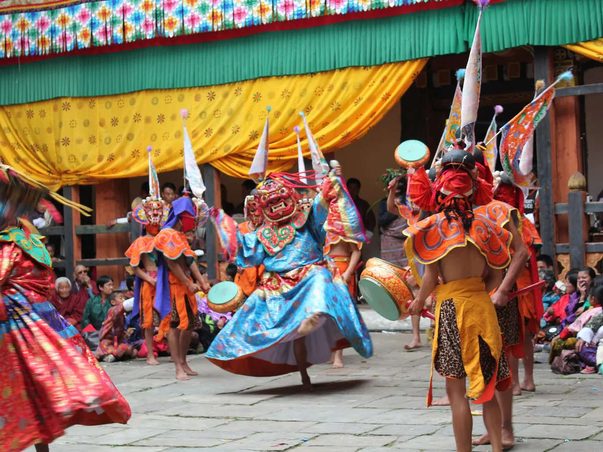 Cham dancers in carved masks at the Jakar tshechu