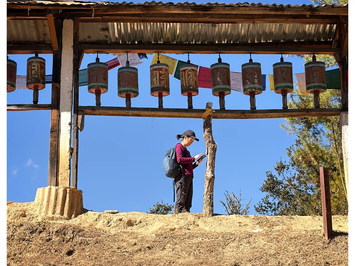 Prayer wheels turning in a ridge-top gate above the trail